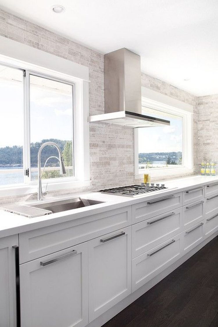white kitchen cabinets with navy blue island